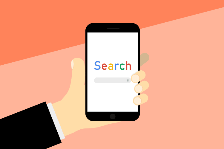 Hand holding a smartphone with Google search open